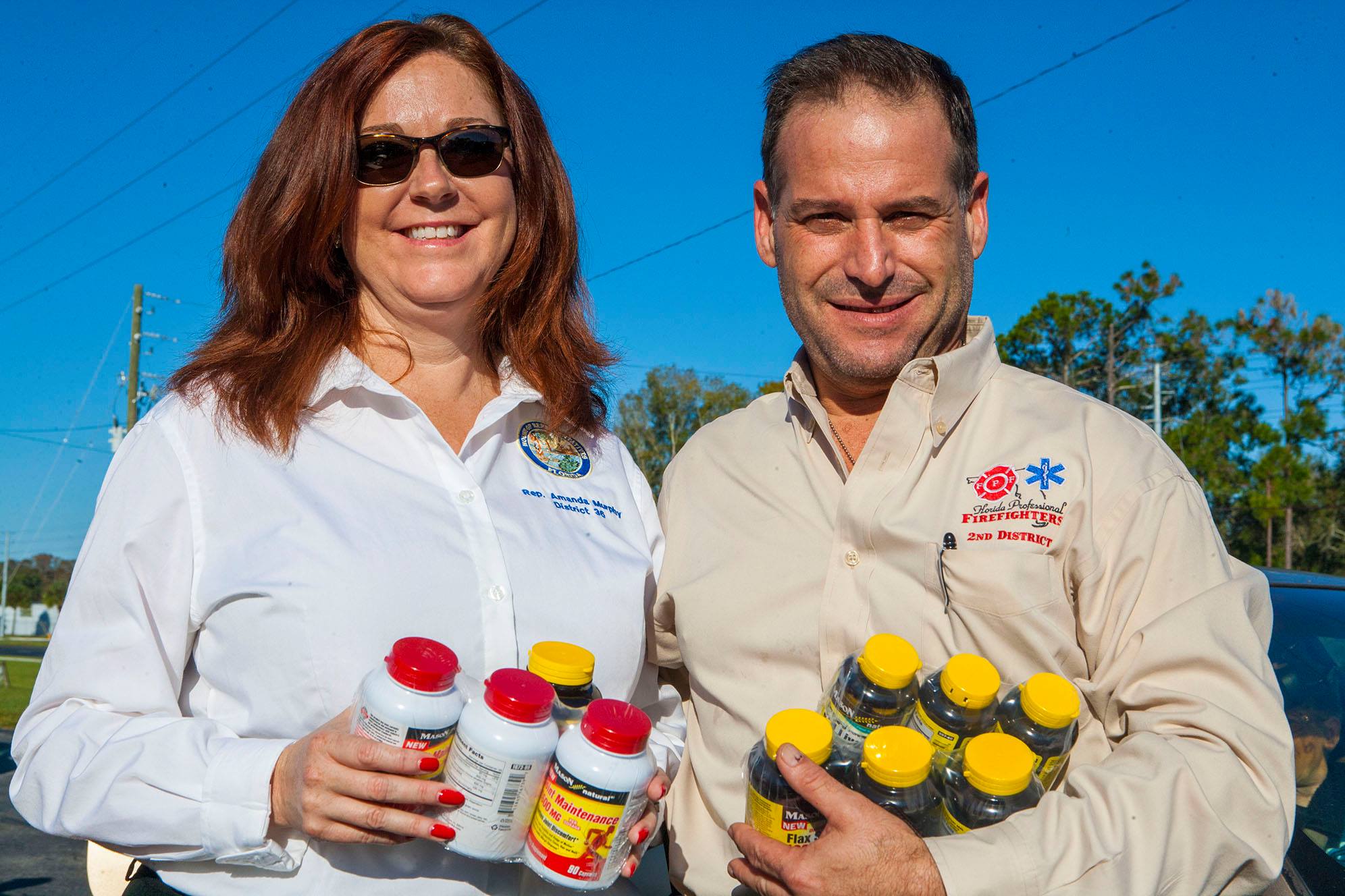 Rep. Amanda Murphy (Dist. 36), and Pasco County Professional Firefighter, IAFF 4420, Joe Russo helped distribute donated vitamins to the 600 bags awaiting the needy. 